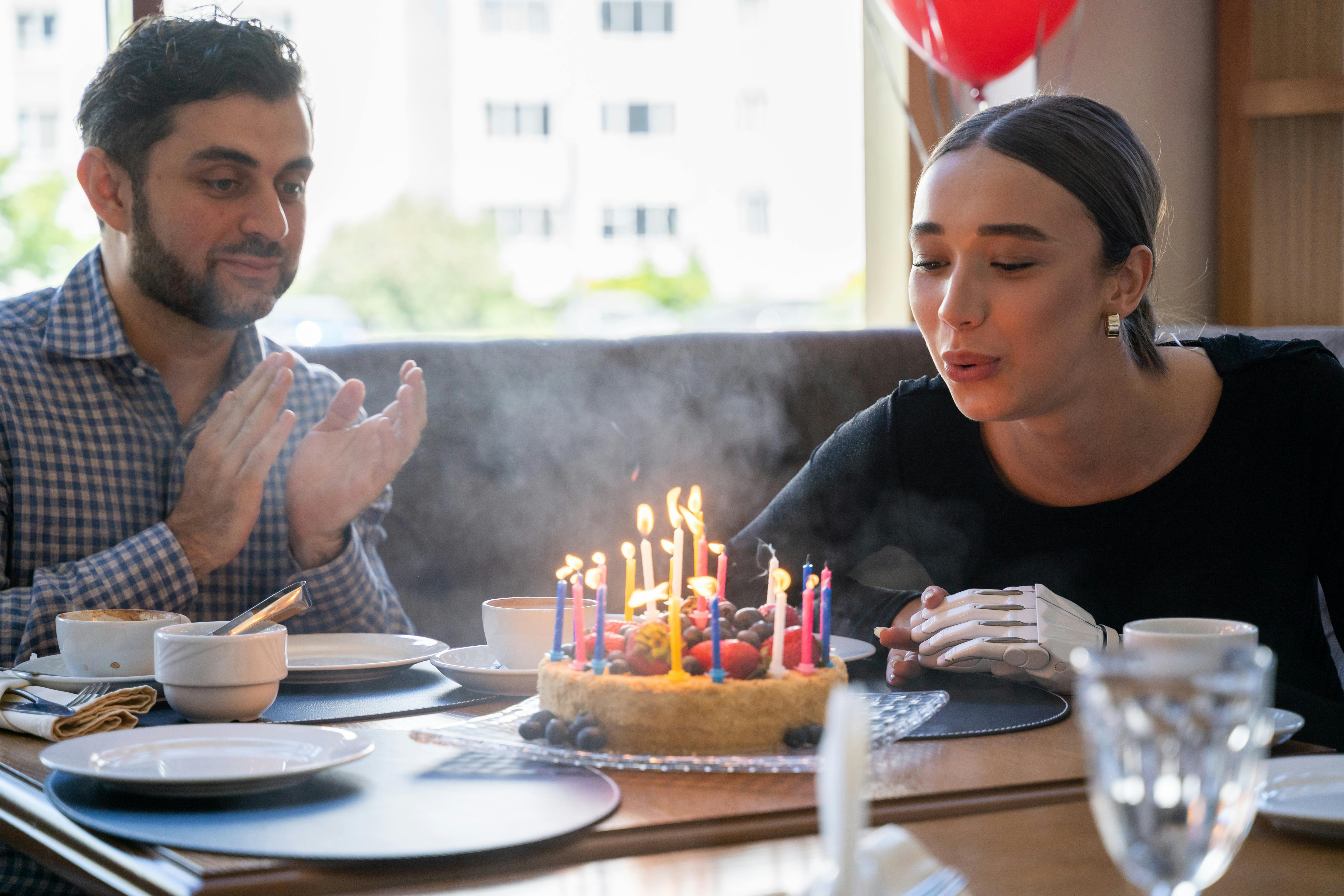 Birthday girl blowing out candles on cake